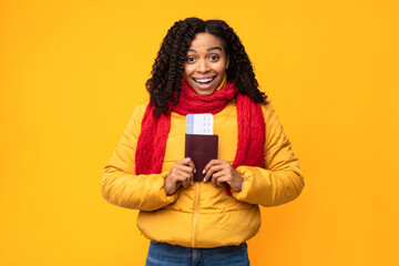 Joyful African Tourist Lady Holding Tickets Posing Over Yellow Background