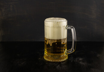 A glass of light beer with foam