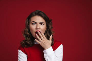 Beautiful shocked girl expressing surprise and covering her mouth