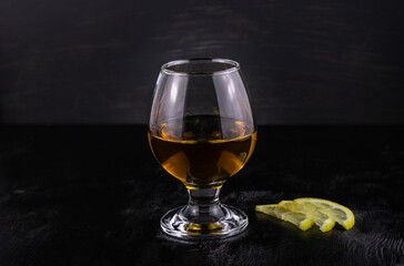 Glass of cognac with lemon