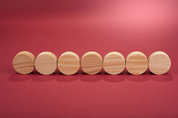Blank wooden circles for conceptual sign on a red