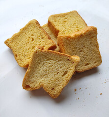 crispy rusk, cake rusk, cardamom rusk, Crunchy or Toast for healthy life, Traditional biscuit tray with tea, toasts for breakfast and cup of fresh milk & Tea, dry toasty bread, crunchy toast, pau, pav