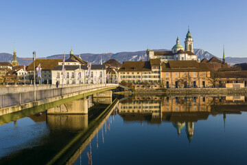 Riverside of Aare and houses dominated by Saint Ursus Cathedral in Solothurn, Switzerland