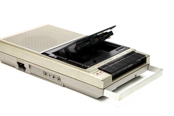 Old vintage portable cassette player from the 1980s isolated on a white background