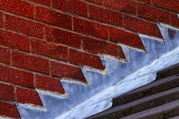 Stepped lead flashing roof gulley creating a water tight seal between roof tiles and brick wall on a domestic house © Andrew Gardner