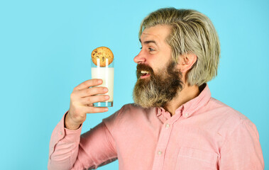 happy farmer eat dessert. bearded man drink useful milk with pastry. cookie and glass of milk. man love bakery. bakery goods concept. his favorite food. enjoying freshly baked pastries