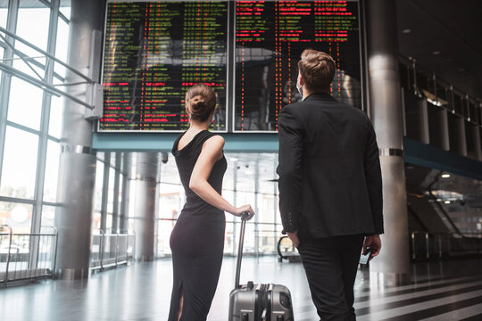 Man and woman looking at the timetable in the airport
