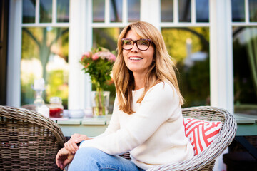 Happy woman relaxing on the balcony at home