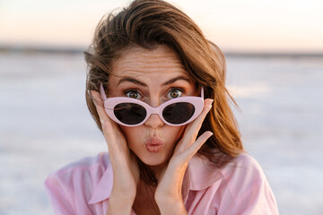 Surprised shocked young girl in sunglasses