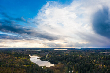 Aerial photo of a countryside landscape with forest and lakes and clouds