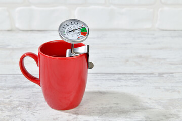 Checking the heat of coffee using barista thermometer 
