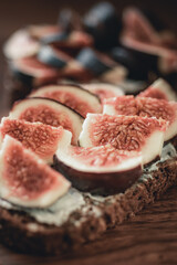 Fig pieces with cheese on rustic bread.