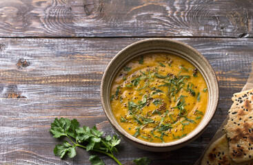 Indian lentil masurdal soup with turmeric, ginger and herbs, top view, space
