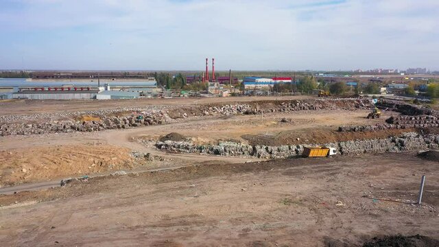 aerial video of a city garbage dump in the background of the city,