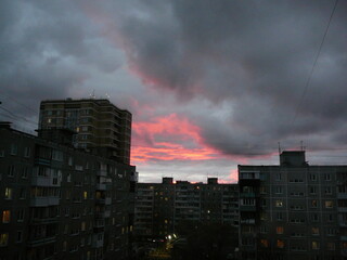 clouds and colorful sunset over city