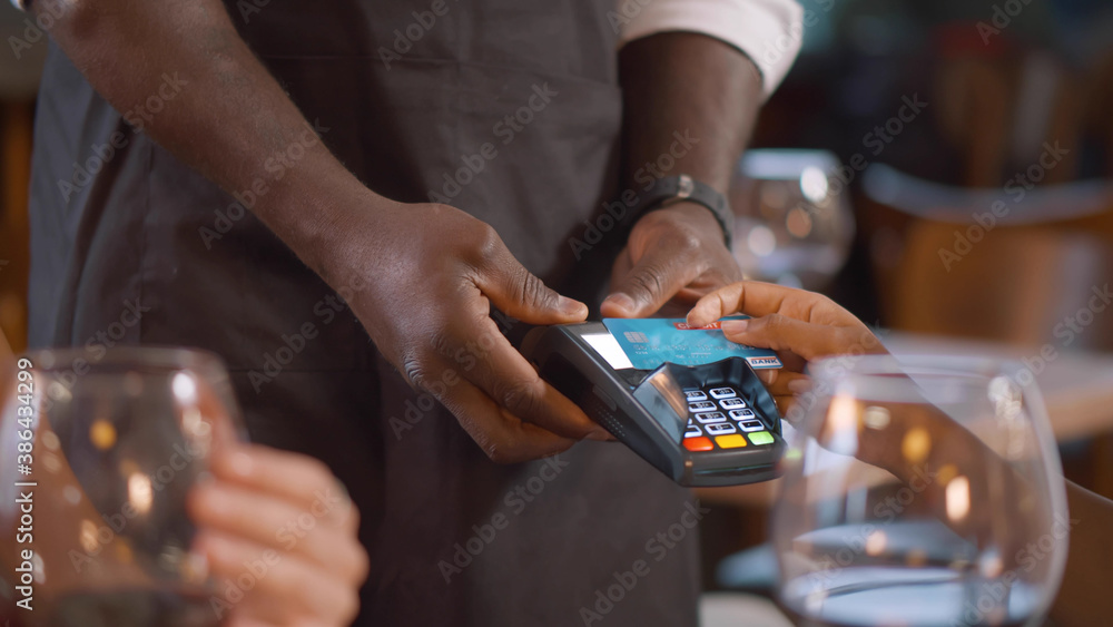 Wall mural close up customer make contactless credit card payment after eating in restaurant