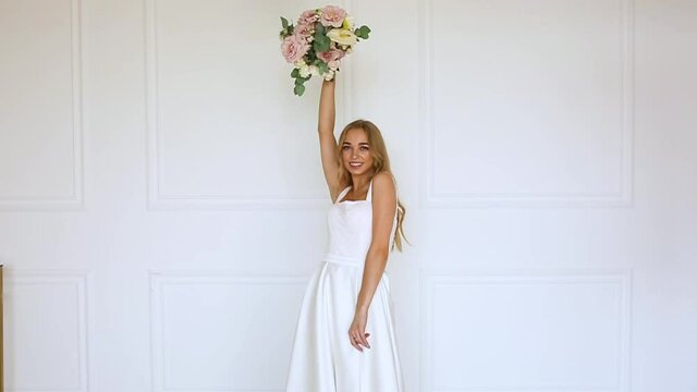 female hands a gift bouquet of flowers Bride in white dress Woman blonde
