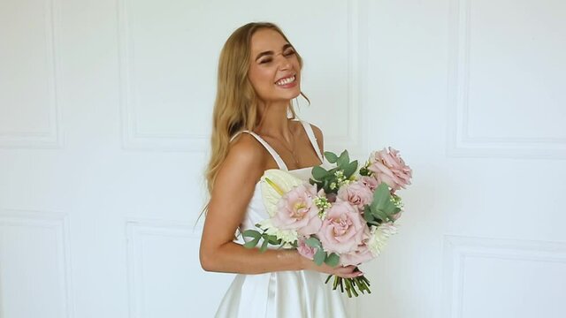 female hands a gift bouquet of flowers Bride in white dress Woman blonde
