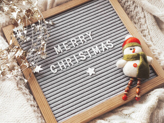 Letter board with season greeting Merry Christmas. Winter holiday spirit. Decorative snowman and...