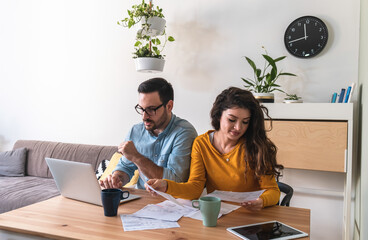 Worried couple calculating and paying bills online stock photo