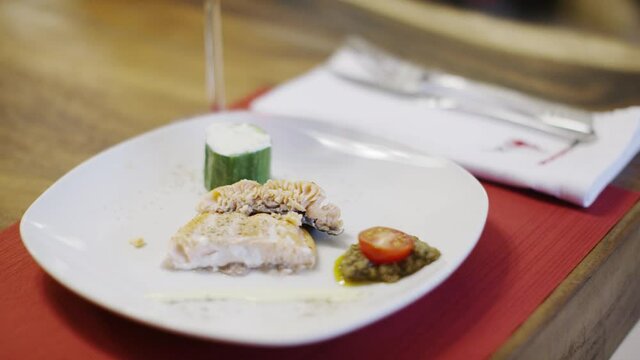 Fish served with tomate and cucumber