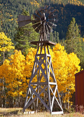 Windmill with changing colors of the Aspen Trees as a backdrop