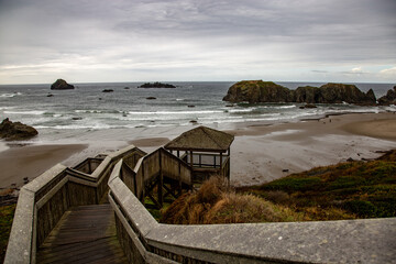 long wooden stairway leading to a rocky beach