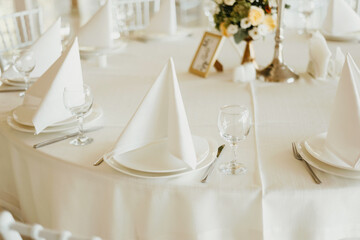 Photo of a wedding white table beautiful arranged ready for event