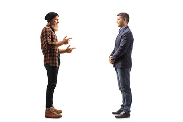 Full length profile shot of a bearded guy standing and talking to a man