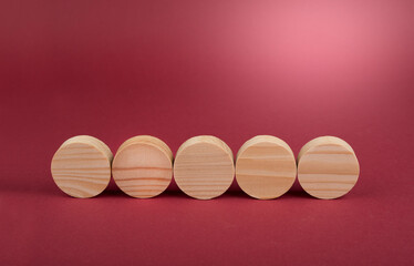 Blank wooden circles for conceptual sign on a red