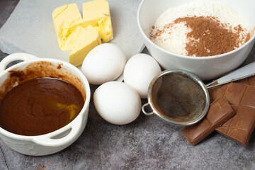 ingredients for chocolate baking on gray background.