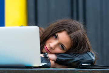 businesswoman taking a break from her work schedule leaning forwards to relax on her folded arms
