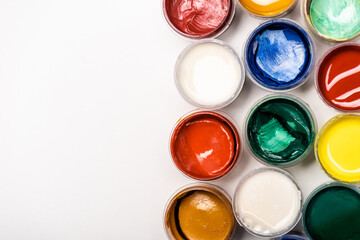 top view of colorful Gouache paints on white background