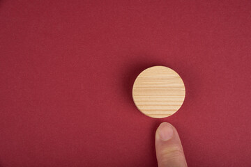 Blank wooden circle for conceptual sign on a red