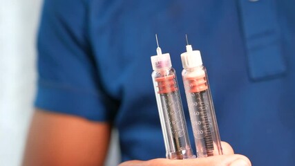 Man hand holding Insulin pens close up 