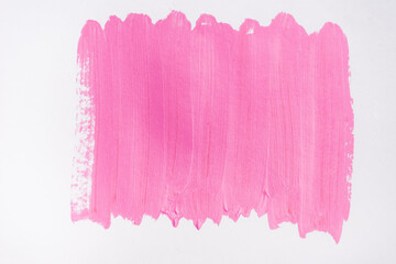 top view of abstract pink paint brushstrokes on white background