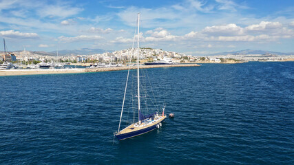 Fototapeta na wymiar Aerial drone photo of beautiful luxury sailboat with wooden deck anchored near famous marina of Zea, Piraeus, Attica, Greece