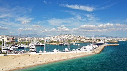 Obraz premium Aerial drone panoramic photo of iconic round port and marina of Zea in the heart of Piraeus with beautiful sky and clouds, Attica, Greece