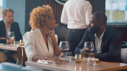 African couple enjoying romantic date in restaurant.