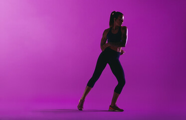 Fototapeta na wymiar Fitness woman working out on purple background