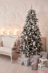 Christmas tree with a white sofa in a white room