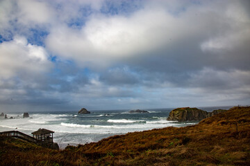 wooden stairway leading to a rocky beach