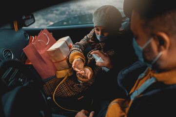 Family shopping Christmas gifts during COVID-19 pandemic. They wears a protective mask to protect from coronavirus