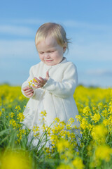 girl in a field of yellow flowers