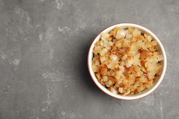 Tasty fried onion on grey table, top view. Space for text