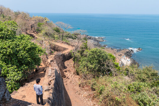The young man looks at the Indian ocean from the height of the former Portuguese fortress of Cabo de Rama in Goa, India