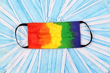 Multicolored protective mask. Disposable medical mask painted with gouache in rainbow colours. Many...