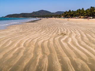 Sand waves on the beach after the Indian ocean low tide in Goa, India