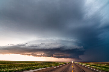 Supercell storm clouds over a road