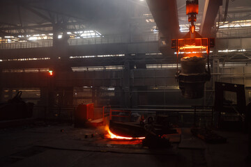 Iron casting and the foundry. Overhead crane with ladle with molten metal at metallurgical factory